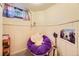 Charming bedroom featuring a purple chair, small window, and unique decorative touches at 944 S Euclid Way, Denver, CO 80209