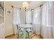 Bright breakfast nook filled with lots of light from bay windows and featuring a round table with seating for two at 944 S Euclid Way, Denver, CO 80209