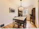 Bright dining room with a marble-top table, stylish lighting, hardwood floors, and ample natural light at 944 S Euclid Way, Denver, CO 80209