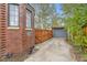 Brick house exterior with a wooden fence, driveway and detached garage at 944 S Euclid Way, Denver, CO 80209