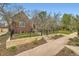 Beautiful brick home with manicured lawn, stone front wall, and wrought iron fence creating a welcoming entrance at 944 S Euclid Way, Denver, CO 80209