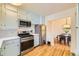 Cozy kitchen features stainless steel appliances, light blue cabinetry, and a dining area for a classic touch at 944 S Euclid Way, Denver, CO 80209
