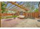 Outdoor patio area featuring a wooden pergola, comfortable seating, and a well-manicured lawn at 944 S Euclid Way, Denver, CO 80209