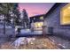 Deck and patio area with wooded backdrop at 6517 Perry Park Blvd, Larkspur, CO 80118