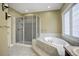 Spa-like bathroom featuring a large shower and soaking tub at 6517 Perry Park Blvd, Larkspur, CO 80118