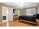 Bright bedroom with wood floors and en-suite bathroom at 6517 Perry Park Blvd, Larkspur, CO 80118