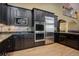 Dark wood kitchen cabinets, granite countertops, and stainless steel appliances at 6517 Perry Park Blvd, Larkspur, CO 80118