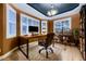 Home office with built-in shelving and hardwood floors at 6517 Perry Park Blvd, Larkspur, CO 80118