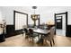 Elegant dining room features modern light fixture, wainscotting, large windows and an open doorway at 2844 N Humboldt St, Denver, CO 80205