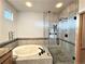 Well-lit bathroom highlighting a soaking tub and separate glass shower, offering a spa-like retreat for relaxation and rejuvenation at 588 Stafford Cir, Castle Rock, CO 80104