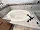 Close up of a soaking tub nestled in a luxurious bathroom featuring modern fixtures and elegant tile work at 588 Stafford Cir, Castle Rock, CO 80104