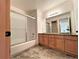 Bathroom with double sink vanity, granite countertops, and a tiled shower with glass door at 588 Stafford Cir, Castle Rock, CO 80104