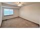 Bright bedroom with neutral carpet, a ceiling fan and a window at 588 Stafford Cir, Castle Rock, CO 80104