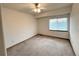 A bright bedroom with neutral carpet, a ceiling fan and a window at 588 Stafford Cir, Castle Rock, CO 80104