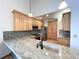 Well-lit kitchen showcasing wood cabinets, granite countertops, stainless steel appliances and a mosaic backsplash at 588 Stafford Cir, Castle Rock, CO 80104