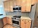 Close up of kitchen featuring wood cabinets, granite countertops, stainless steel appliances and a mosaic backsplash at 588 Stafford Cir, Castle Rock, CO 80104