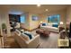 A modern living room with wood accent wall, lots of natural light, and staged furniture at 588 Stafford Cir, Castle Rock, CO 80104