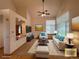 Cozy living room showcasing vaulted ceiling, updated furniture, and a stylish pass-through to the adjacent room at 588 Stafford Cir, Castle Rock, CO 80104