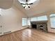 Spacious living room showcasing a stone fireplace, hardwood floors, vaulted ceilings and large windows at 588 Stafford Cir, Castle Rock, CO 80104