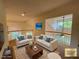 A bright, inviting living room with two couches and view of the upper landing at 588 Stafford Cir, Castle Rock, CO 80104