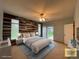 Serene main bedroom with a feature accent wall, large windows, and a calming color palette for relaxation at 588 Stafford Cir, Castle Rock, CO 80104