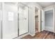 Modern bathroom with glass-enclosed shower and wood-look floors, bright and inviting at 19018 E 94Th Pl, Commerce City, CO 80022