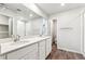 Bathroom with double sinks and sleek countertops, complemented by wood-look flooring at 19018 E 94Th Pl, Commerce City, CO 80022