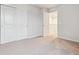 Bright bedroom features neutral paint, plush carpeting, and a spacious closet at 19018 E 94Th Pl, Commerce City, CO 80022