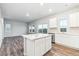 Open-concept kitchen with white cabinets, stainless steel appliances, and a kitchen island at 19018 E 94Th Pl, Commerce City, CO 80022