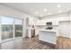 Open-concept kitchen with white cabinets, stainless steel appliances, and a center island at 19018 E 94Th Pl, Commerce City, CO 80022