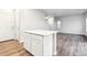 Kitchen with white cabinets, hardwood floors, and a center island for preparing food at 19018 E 94Th Pl, Commerce City, CO 80022