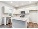Bright kitchen with white cabinets, stainless steel appliances, and a center island at 19018 E 94Th Pl, Commerce City, CO 80022