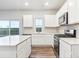 Modern kitchen with stainless steel appliances, white cabinets and counter tops at 19018 E 94Th Pl, Commerce City, CO 80022