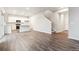 Open-concept living area with hardwood floors, a kitchen with stainless steel appliances, and a staircase at 19018 E 94Th Pl, Commerce City, CO 80022