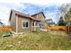 Backyard of a two story home featuring a patio and green grass and a wooden fence at 4165 S Granby Cir, Aurora, CO 80014