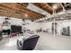 Large unfinished basement with exposed beam ceiling, bright carpet, and ample storage space at 4165 S Granby Cir, Aurora, CO 80014
