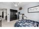 Cozy bedroom with a floral bedspread, dresser, and double closet at 4165 S Granby Cir, Aurora, CO 80014