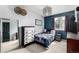 Cozy bedroom with a floral bedspread, dresser, and lots of natural light at 4165 S Granby Cir, Aurora, CO 80014