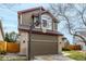 Two-story home with a two-car garage, basketball hoop, brick accents, and landscaping at 4165 S Granby Cir, Aurora, CO 80014