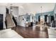 Spacious living room with hardwood floors, dining area, and staircase at 4165 S Granby Cir, Aurora, CO 80014