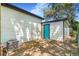 Quaint fenced backyard featuring white siding, a blue door, and a modern AC unit at 1219 Lilac Dr, Lochbuie, CO 80603
