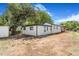View of backyard with a white house, contrasting black trim, and minimal landscaping at 1219 Lilac Dr, Lochbuie, CO 80603