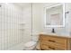Updated bathroom featuring a modern vanity, sleek fixtures, and tiled shower at 1219 Lilac Dr, Lochbuie, CO 80603