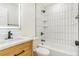 Modern bathroom features white subway tile in shower with black hardware and a wooden vanity at 1219 Lilac Dr, Lochbuie, CO 80603