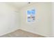 Bright bedroom with neutral carpet and a large window providing natural light at 1219 Lilac Dr, Lochbuie, CO 80603
