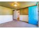 Carpeted bedroom with a door that has direct access to the home's exterior at 1219 Lilac Dr, Lochbuie, CO 80603