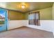 Carpeted bedroom featuring a door to outside and neutral walls for a serene living space at 1219 Lilac Dr, Lochbuie, CO 80603