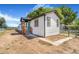 Charming home featuring white siding, black trim, and a welcoming blue front door at 1219 Lilac Dr, Lochbuie, CO 80603