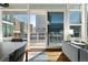 Balcony access from living space with city views and natural light streaming through sliding glass doors at 1620 Little Raven St # 302, Denver, CO 80202