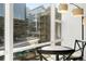 Urban views from breakfast nook with table and chairs; natural light streaming through the large window at 1620 Little Raven St # 302, Denver, CO 80202